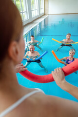 People in aqua fitness class during a physical therapy session in a physiotherapy center - 642512977