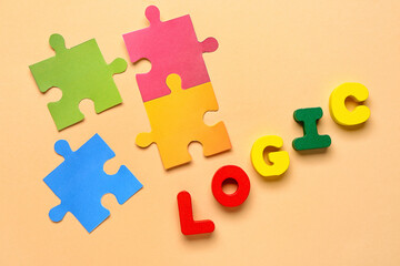 Word LOGIC with paper puzzle pieces on beige background