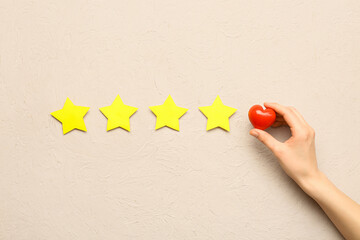 Woman with heart and stars on grunge background. Customer experience concept