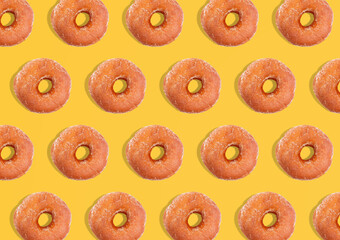 Creative pattern donuts flat lay on pastel yellow background. Minimal sweet food concept. Surreal original donuts cake top view for bakery. - obrazy, fototapety, plakaty