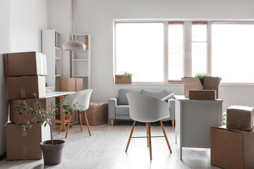 Modern workplaces with cardboard boxes in office on moving day