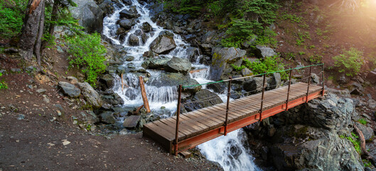 Hiking path and bridge across a river in the Canadian Nature mountains. © edb3_16