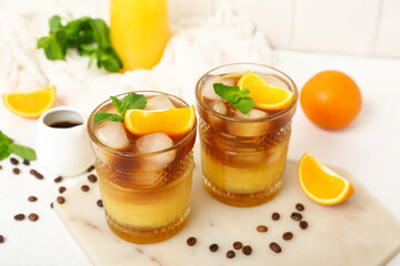 Glasses of tasty orange espresso on table