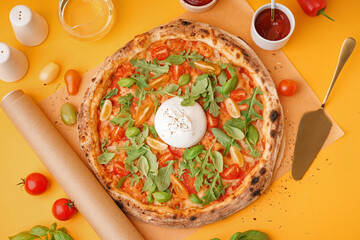 Tasty pizza with Burrata cheese on orange background