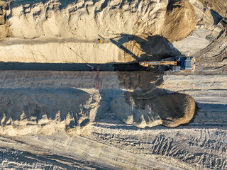 excavator on construction site digging and dumping dirt