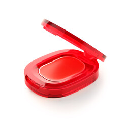 Compact red lipstick on white background