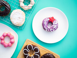 Creative flat lay of delicious glazed donuts