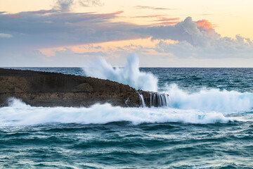 Wave breaking at sunset
