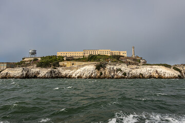 San Francisco, CA, USA - July 12, 2023: Alcatraz Island west rocky shite-guano covered cliffs....