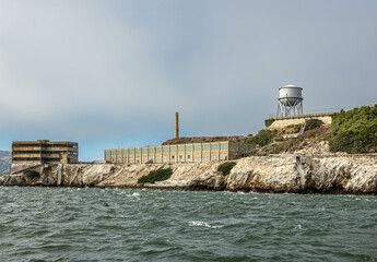 San Francisco, CA, USA - July 12, 2023: Alcatraz Island NW tip closeup with tall chimney and new...