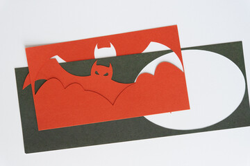 machine-cut stylized dingbat shape and corresponding stencil cutout on blank white paper and green...