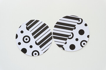 machine-cut paper circles featuring stripes and circles and rings on blank paper