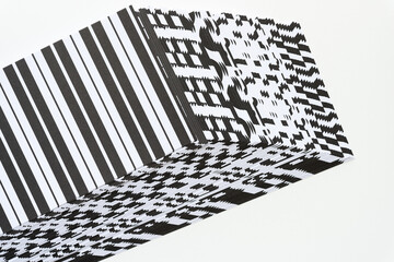 optical illusion 3d paper shape (cube or box) composed with pile of black and white paper sheets...