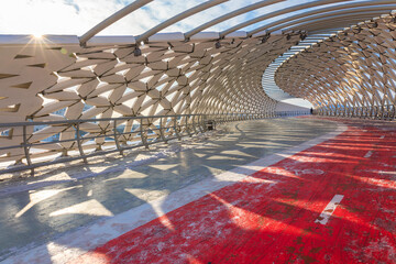 Modern architectural urbanistic Atyrau fish bridge across Ishim river. Pedestrian bridge with graceful fish scales interior, Nur-Sultan, Astana, Kazakhstan. High quality photo