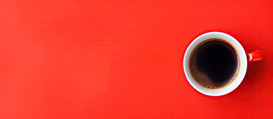Red cup of coffee seen from above with empty background