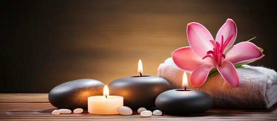 Spa idea including pink salt essential oil candle stones and flower on wood