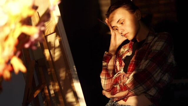 Portrait of exhausted young woman artist student with failed ideas while take a break at creative workshop Lack of inspiration and creative crisis concept