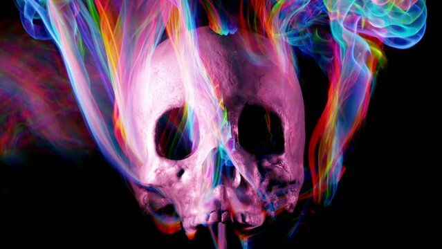 Scary human skull surrounded by funky moving colors.