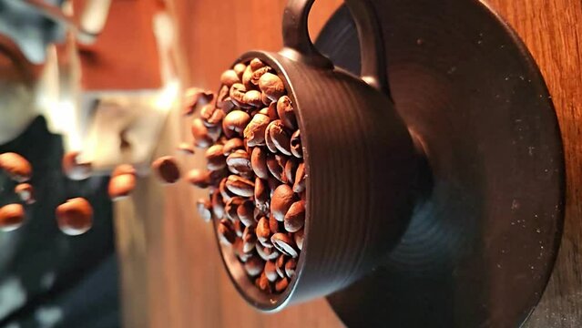 Coffee bean, coffee beans falling in super slow motian into a black cup on rustic surface, vertical video.