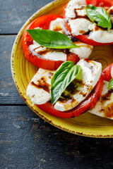 Italian traditional Salad Caprese on dark background. Italian cuisine. Close up