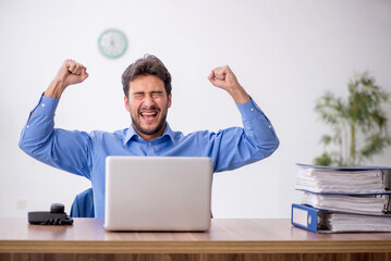 Young male employee working in the office