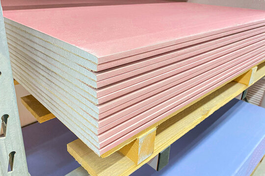 The stack of Plasterboard fire resistant gypsum board cardboard surface Panel Type DF for indoor concrete walls prepared for construction, selective focus