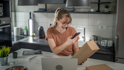 one woman checking box of received package or product at home