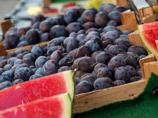European Prune Plums Displayed Outside a Small Fruit and Vegetable Store