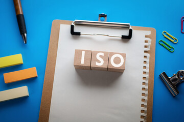 There is wood cube with the word ISO. It is an abbreviation for International Organization for...