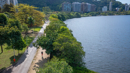 Aerial view of the leisure area and running track at Lagoa Rodrigo de Freitas, where people are jogging and exercising on a beautiful winter's morning in Rio de Janeiro.