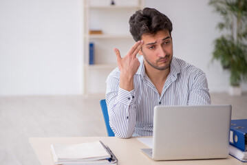 Young male employee working in the office