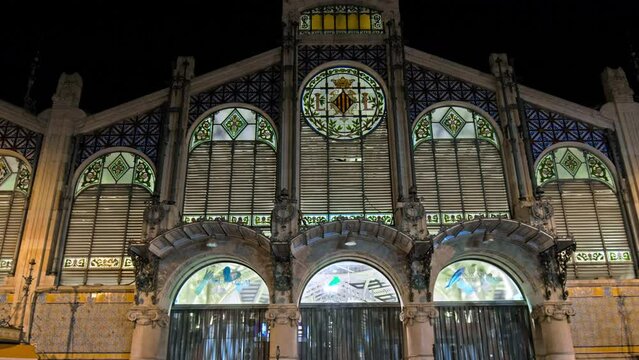 Mercat Central de Valencia - Modernista market building with colourful tiles. Beautiful Spanish building at night with a diverse collection of stalls.