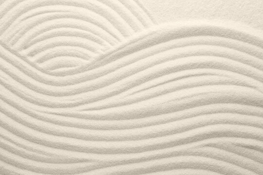 White sand with pattern as background, top view. Concept of zen and harmony