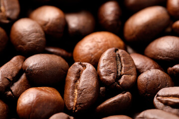 Naklejka premium Aromatic roasted coffee beans as background, closeup