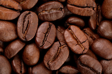 Aromatic roasted coffee beans as background, top view