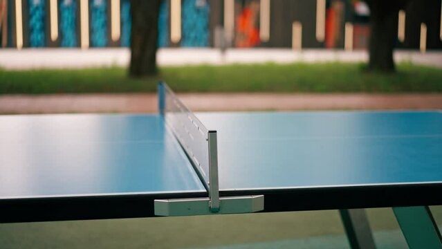 blue tennis table with net in city park outdoor table tennis game sport and leisure concept