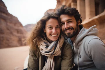 Fototapeten Couple in their 30s smiling at the Petra in Maan Jordan © Anne Schaum