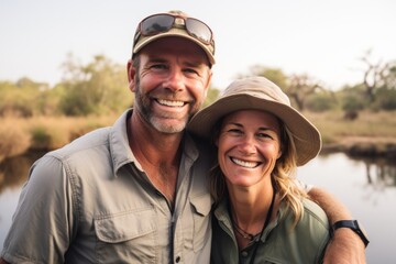 Couple in their 40s smiling at the Okavango Delta in Botswana