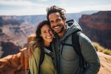 Naklejka premium Couple in their 30s smiling at the Grand Canyon in Arizona USA