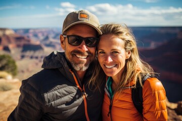 Couple in their 40s smiling at the Grand Canyon in Arizona USA