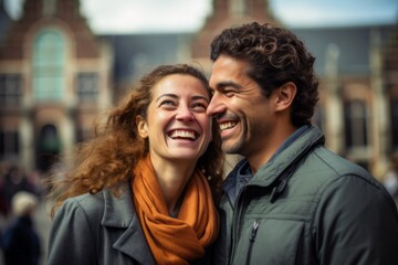 Fototapeta premium Couple in their 30s smiling at the Rijksmuseum in Amsterdam Netherlands