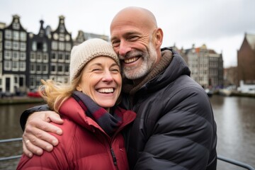 A couple in their 40s smiling at the Anne Frank House in Amsterdam Netherlands