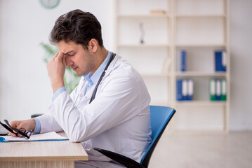 Young male doctor working in the clinic