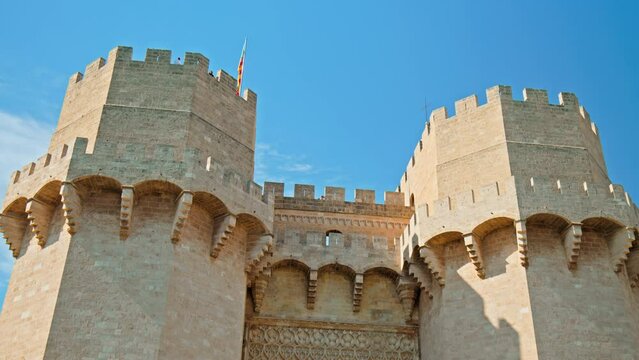 Imposing Gothic-style Torres de Serranos part of the old city walls of Valencia. Beautiful historical twin towers Portal dels Serrans offering views of Valencia and the river.