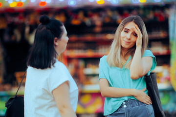 Woman Having a Headache After Talking to a Friend. Bored girl meeting an annoying person listening...