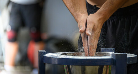 Chalking Hands at a Weightlifting Event