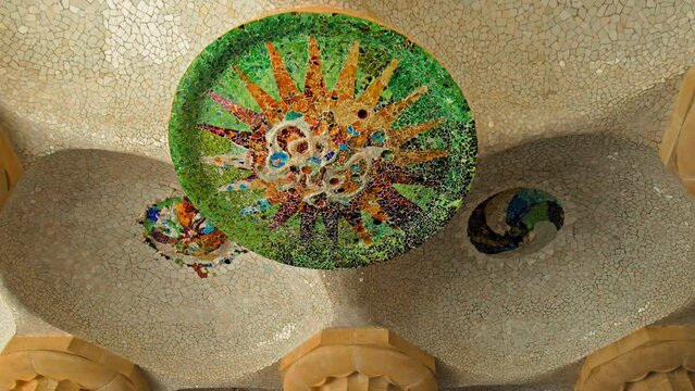Abstract Colourful Mosaic-covered building ceiling. Creative design of an oval ceiling supported by big pillars