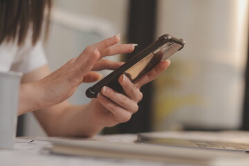 Cropped photo of Freelancer business Asian woman holding coffee cup and at doing planning analyzing the financial report, business plan investment, finance analysis the workplace.