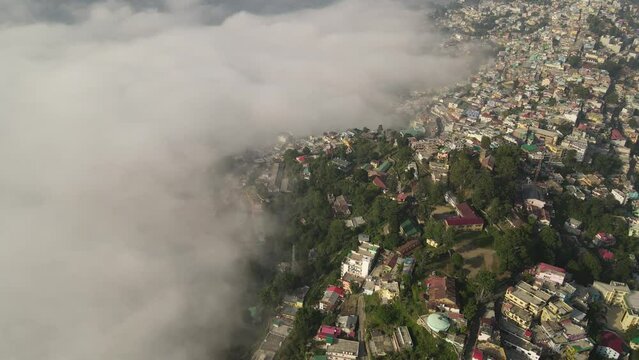 Aerial shot of almora city, situated in mountains covered with clouds. 