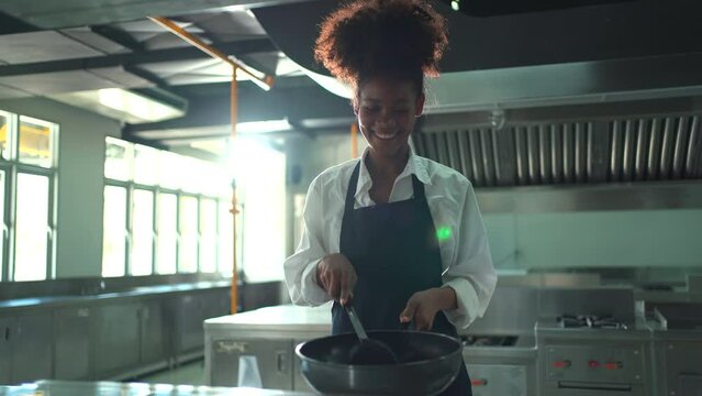 Happy cheerful junior Asian chef showing a beautiful smile to camera while in kitchen.